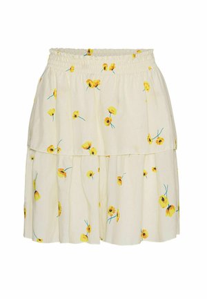 Jupe à volants couleur crème avec taille élastique, décorée de petites fleurs jaunes imprimées et de tiges vertes.