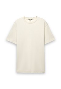 T-shirt di cotone color crema con vestibilità comoda, maniche corte e scollatura rotonda. Tessuto liscio senza motivi o dettagli visibili.