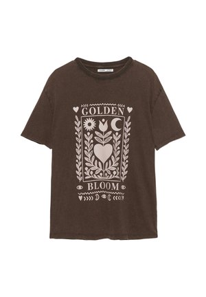 Rjava bombažna majica s kratkimi rokavi, ki prikazuje belo grafično tiskanje z cvetličnimi in nebeškimi motivi ter napisom "ZLATI CVET".