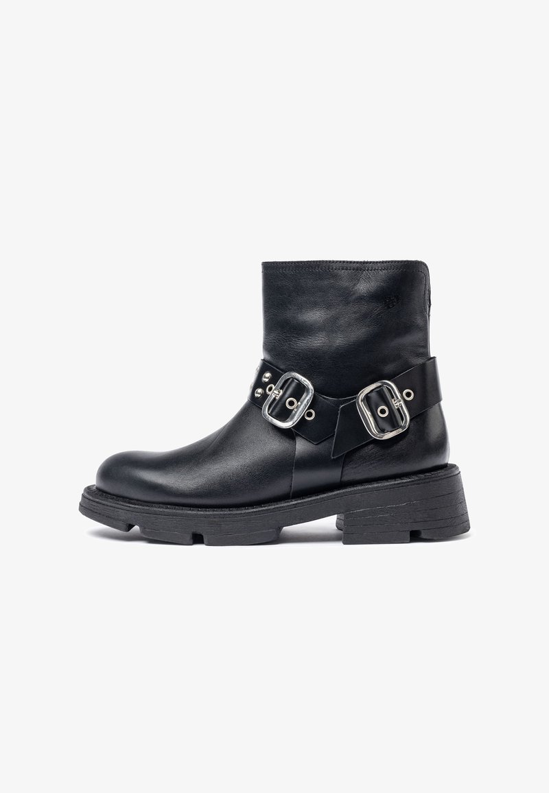 Black leather ankle boot with a rounded toe, silver buckle accents, and a textured black platform sole.  Minimalist design, mid-height shaft.