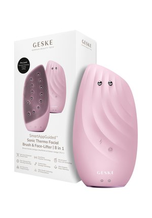 Brosse faciale thermo-sonique rose portable avec surface texturée et nœuds métalliques, avec sa boîte d’emballage blanche contenant les détails du produit.