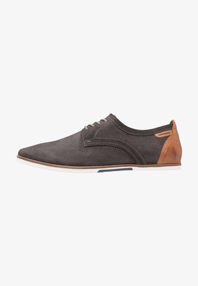 Chaussure à lacets en cuir texturé gris foncé avec semelle blanche et empiècement en cuir marron au talon, vue latérale sur fond blanc.