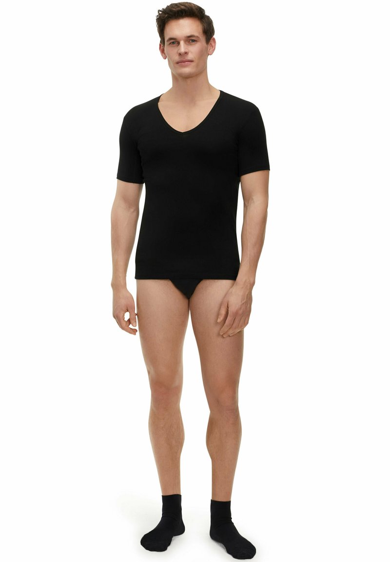 Black short-sleeve V-neck shirt in a smooth fabric, fitted shape, worn with black briefs and socks, displayed on a standing model.