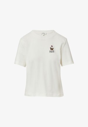 T-shirt blanc à manches courtes en coton, avec un design de cupcake brodé et le texte "DOUX COMME UN CUPCAKE" en noir.