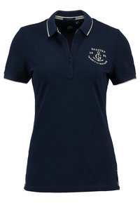 Polo-shirt bleu marine en coton, avec un col à garniture légère, un plastron à boutons et des accents de logo brodés. Manches courtes.