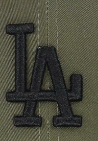 Olive green cap featuring a raised black embroidered "LA" logo. The fabric has a textured, woven appearance with visible stitching.