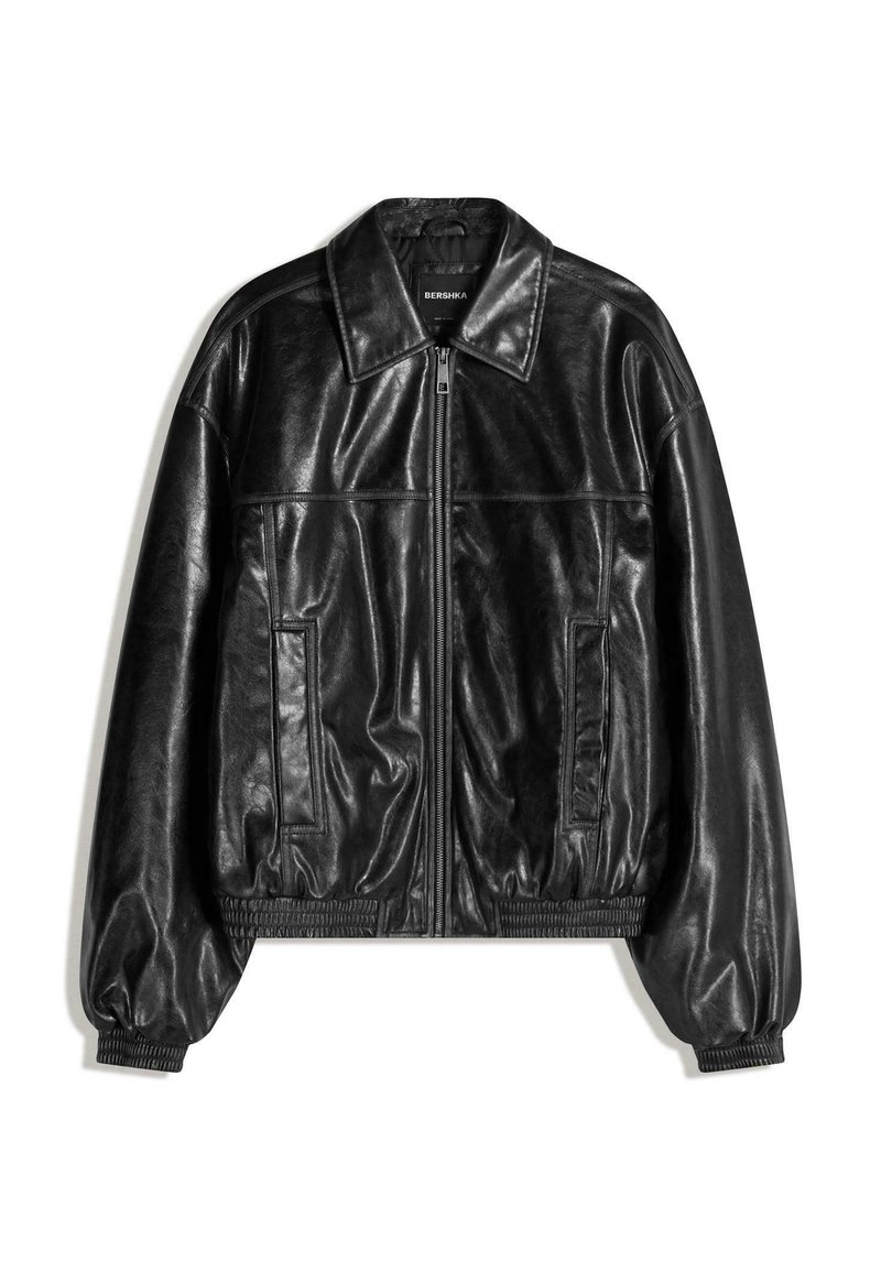 Black leather bomber jacket with a front zip closure, large collar, side pockets, and ribbed cuffs and hem. Smooth texture and relaxed fit.