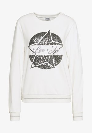 Bílá mikina s dlouhým rukávem s černou hvězdou z flitrů a nápisem "Liu Jo" uprostřed přední části, žebrované manžety a lem se stříbrnými pruhy.