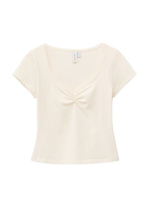 Kreemjas lühikese varrukaga lühike top ümmarguse kaelusega ja keskelt ees kokku kogutud detailiga.