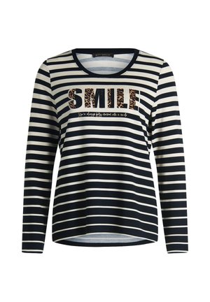 Chemise à manches longues rayée en bleu marine et crème. Présente un graphisme "SMILE" en imprimé léopard et un tissu doux avec un col rond.