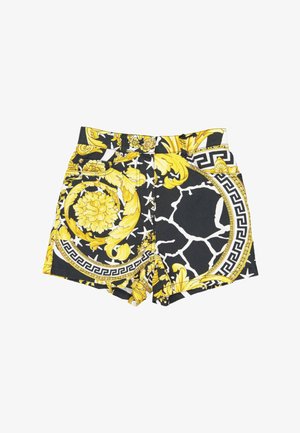 Pantalones cortos de talle alto con estampados en negro, blanco y amarillo con diseños barrocos florales y geométricos y trabillas para cinturón.