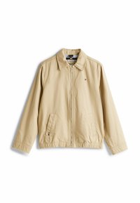 Veste légère beige avec une fermeture éclair à l'avant, un col pointu, une taille élastiquée et deux poches latérales. Présente un petit logo sur la poitrine.