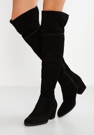 Black suede over-the-knee boots with a block heel, featuring a stitched seam detail along the shaft and a pointed toe design.