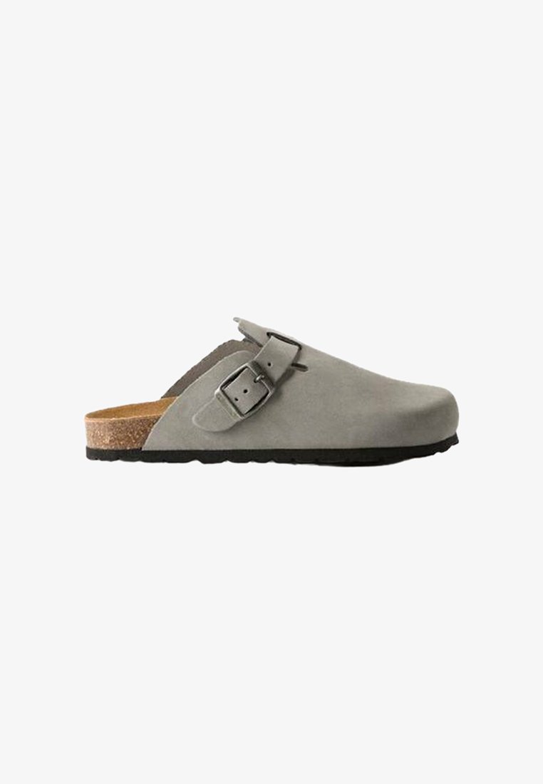 Gray suede clog with a wide strap and adjustable metal buckle, featuring a cork footbed and a textured rubber outsole.