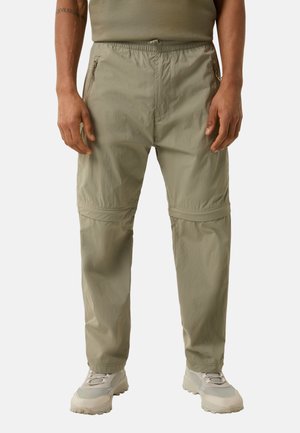 Lys khaki bukser med elastisk talje, lynlåslommer i siden, lige skæring og en subtil tekstur. Sammen med lyse sneakers.