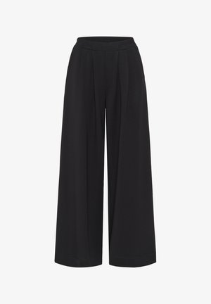 Fekete, bő szárú, magas derekú nadrág redőkkel, testhezálló derékpánttal és elülső rejtett záródással.