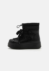 Black ankle boots featuring a padded upper, round toe, lace-up closure, and a thick platform sole for enhanced height and stability.