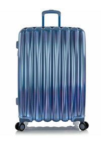 Hard-shell suitcase in gradient blue with vertical ridges, a telescopic handle, and four black wheels for mobility.