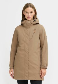 Langer beiger Parka mit hohem Kragen und Kapuze. Verfügt über eine mit Reißverschluss verschließbare Brusttasche, Seitentaschen und verstellbare Bündchen. Glatter Stoff.