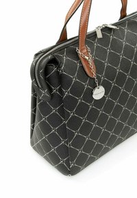 Black patterned handbag with a structured design, featuring brown leather handles and silver hardware, including a decorative chain and tag.