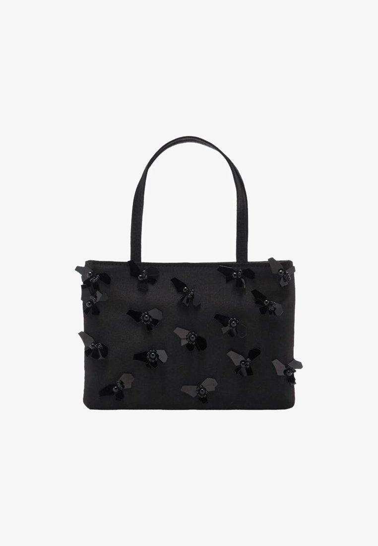 Sac fourre-tout en tissu noir avec des embellissements floraux plats et des centres perlés. Deux poignées et forme rectangulaire, texture lisse.