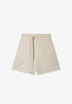Shorts taille haute couleur crème avec ceinture, poches latérales et un logo discret sur la jambe droite, posés à plat sur un fond blanc.