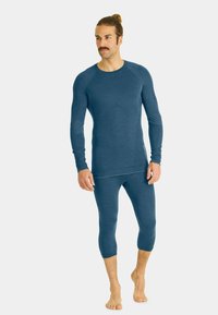 Blue thermal long-sleeve top and cropped bottoms, made of soft fabric with a lightweight texture. Features a rounded neckline and fitted design.