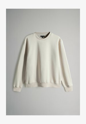 Cremefarvet trøje med rund hals, lange ærmer og ribbede mansjetter. Glat stof, afslappet pasform og minimalistisk design.