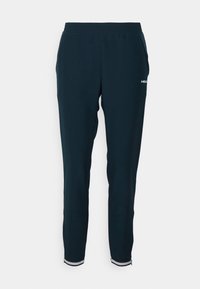 Marinblå sweatpants med elastisk midjeband, sidofickor och vita randiga detaljer vid fållen. Tillverkade av mjukt, flexibelt tyg.