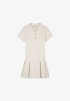 Cream-colored polo dress featuring short sleeves, a cable-knit pattern, and a flared skirt. It includes three buttons at the collar.