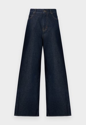 Jean denim bleu marine à jambes larges, avec fermeture par bouton et fermeture éclair, poches avant et arrière, et coutures contrastées.