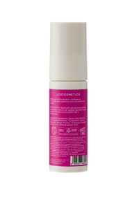 Bottiglia cosmetica con un tappo cilindrico bianco e un'etichetta rosa contenente testo e lista degli ingredienti. Materiale plastico, design compatto.
