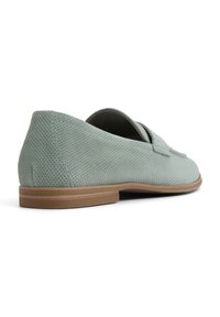 Perforated light green shoe with a smooth texture, almond-shaped toe, and a brown sole. Low profile design with minimal detailing.