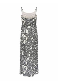 Robe longue sans manches avec fines bretelles, présentant des motifs abstraits de feuilles noir et blanc sur un fond clair.