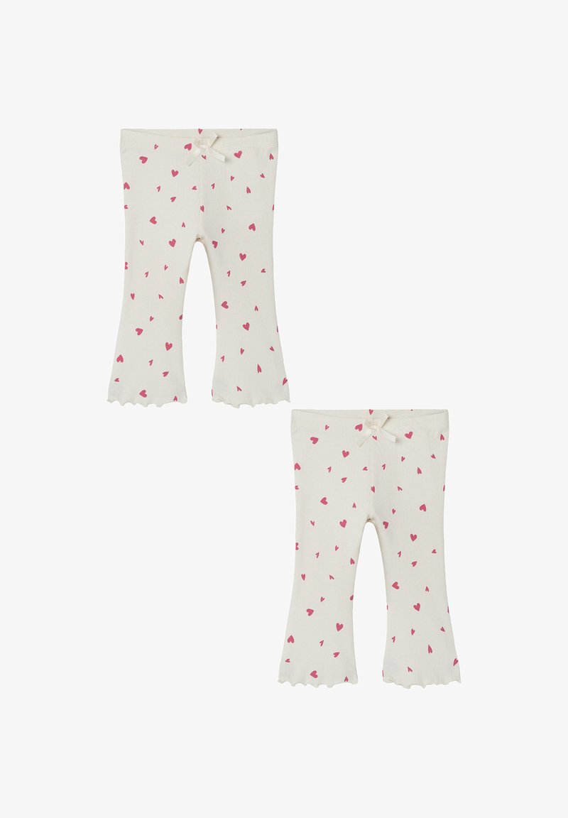 White flared leggings made of soft fabric, adorned with small pink hearts, featuring a scalloped hem and a front bow accent.