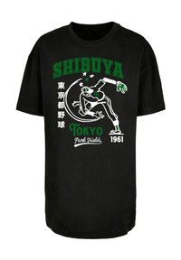 Sort bomulds T-shirt med tekst og grafik i hvid og grøn, herunder "SHIBUYA" og en figur i bevægelse, med "Tokyo Park Fields 1961."