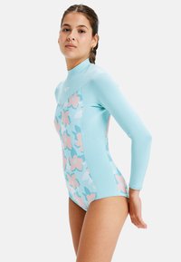 Long-sleeve wetsuit in light blue with floral design in pink and teal. Made of stretchy fabric for comfort and flexibility.