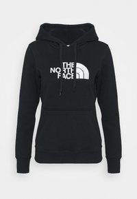Felpa nera con cappuccio realizzata in tessuto misto cotone, con un grande logo bianco e cappuccio con lacci. Include una tasca a canguro frontale.