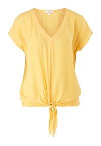 Blouse jaune à manches courtes avec col en V et détail noué à l'avant, en tissu léger et texturé.