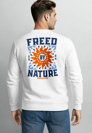 White sweatshirt with colored graphic on the back featuring "FREED BY NATURE" in bold font and a circular sun design, set against a textured backdrop.