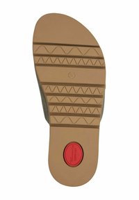 Suela de zapato con banda de rodadura de goma marrón claro con patrones en zigzag y ondas, talla 37, y una etiqueta circular roja de "comodidad" cerca del talón.