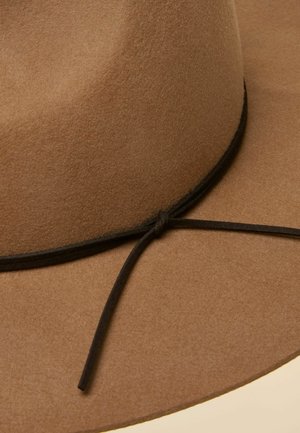 Brown felt wide-brimmed hat with a black tied leather cord around the base of the crown.