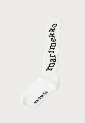 Calzini bianchi a coste con il testo "marimekko" stampato in verticale su un lato e logo sulla suola. Realizzati in materiale lavorato a maglia per maggiore elasticità.