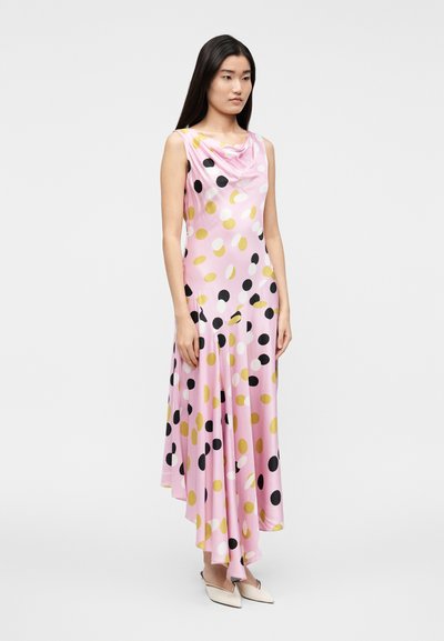 Ujjatlan rózsaszín ruha csőszerű nyakkivágással, nagy fekete, fehér és arany pöttyök vegyes mintájával, sima, áramló anyagból készült.