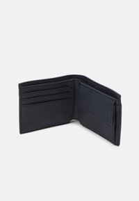 Black leather wallet with multiple card slots, a clear ID pocket, and a textured finish, featuring clean lines and minimal hardware.