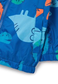 Veste bomber bleue ornée de motifs de dinosaures colorés, dotée d'une fermeture éclair et de poignets élastiqués pour un ajustement parfait.