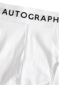 Boxer in cotone bianco con elastico nero in vita riportante la scritta "AUTOGRAPH." Il tessuto è liscio e leggermente elasticizzato.