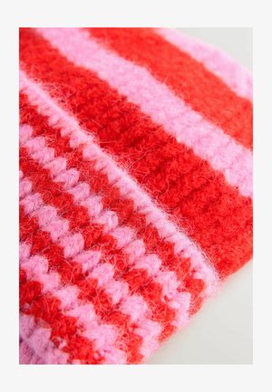 Knitted textile featuring bold red and soft pink stripes. Texture is fuzzy and thick, with alternating patterns of color and weave.