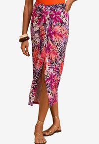Floral mid-length skirt in vibrant pink, purple, and orange hues with a side slit and knotted waist detail. Made from lightweight fabric.
