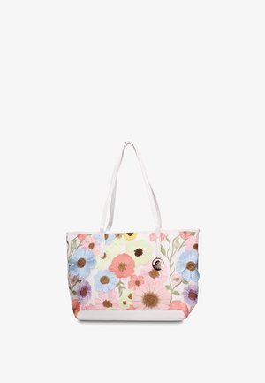 Sac cabas blanc avec des fleurs brodées multicolores et deux bretelles, arborant une petite étiquette de marque ronde en métal.